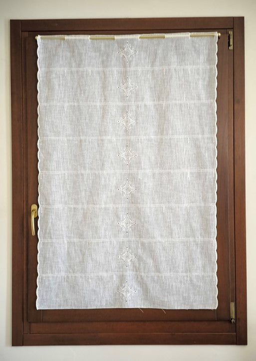 Tenda ricamata con intaglio  appesa a una finestra, elegante e luminosa
